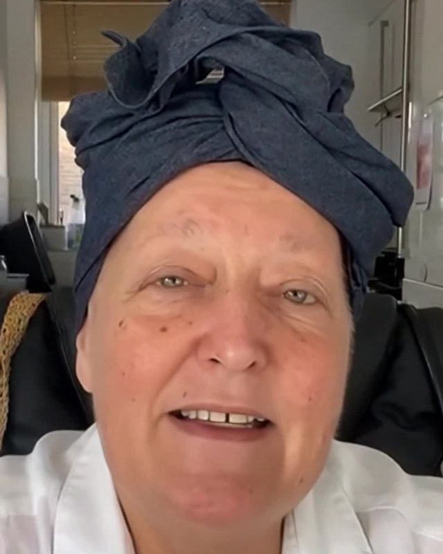 Nicola Cairncross in a navy turban, smiling at the camera